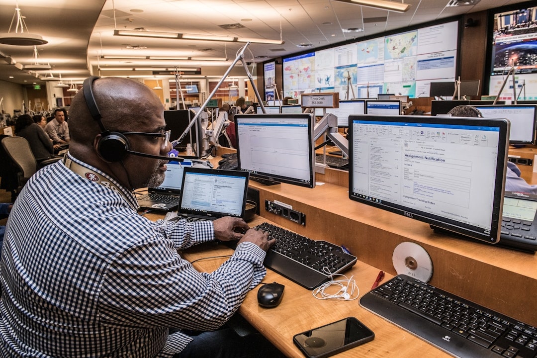 Employee using headset and working on the computer displaying popular contact center solutions